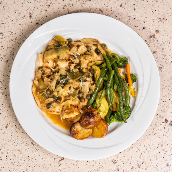 Chicken with artichokes, capers, roasted potatoes, and steamed green beans, broccoli, and yellow squash.